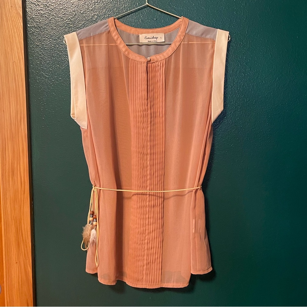 Orange/tan, cream, gray top with feather and bead tie.